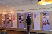 Eine Person steht vor den Bannern aus der Ausstellung "zusammentun – solidarisch gegen rechts". Die Person ist von hinten zu sehen und blickt Richtung Banner.